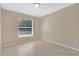 Bedroom with neutral paint and tiled floor featuring a window for ample natural light at 1614 Christa Ct, St Cloud, FL 34772