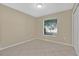 Bedroom with neutral paint and tiled floor featuring a window for ample natural light at 1614 Christa Ct, St Cloud, FL 34772