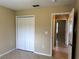 Neutral bedroom featuring a closet, tile flooring, and an adjoining bathroom with matching neutral tones at 1614 Christa Ct, St Cloud, FL 34772