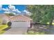 Charming single Gathering home featuring an attached two car garage and mature landscaping at 1614 Christa Ct, St Cloud, FL 34772