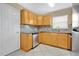 Well-equipped kitchen featuring granite countertops, stainless steel dishwasher, and tiled floors at 1614 Christa Ct, St Cloud, FL 34772