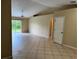 Neutral living area featuring tile floors and sliding glass doors to the backyard at 1614 Christa Ct, St Cloud, FL 34772