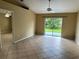 Open living area featuring tile floors and sliding glass doors leading to the backyard at 1614 Christa Ct, St Cloud, FL 34772