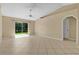 Spacious living room features a sliding glass door, tile flooring, and a ceiling fan at 1614 Christa Ct, St Cloud, FL 34772