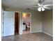Main bedroom with ceiling fan, tile floor, and ensuite bathroom access at 1614 Christa Ct, St Cloud, FL 34772