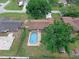 An inviting backyard with a sparkling pool surrounded by mature landscaping and a privacy fence at 1830 W Clinton Dr, St Cloud, FL 34769