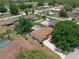 Bird's eye view of a home with backyard pool, mature trees, and long driveway at 1830 W Clinton Dr, St Cloud, FL 34769