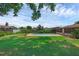 Expansive backyard showcasing a swimming pool, surrounded by a lush green lawn and mature trees at 1830 W Clinton Dr, St Cloud, FL 34769