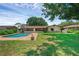 Backyard view featuring a sparkling blue swimming pool and a well-maintained lawn area at 1830 W Clinton Dr, St Cloud, FL 34769