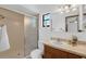 Bathroom featuring a shower, tile backsplash, and vanity with elegant fixtures at 1830 W Clinton Dr, St Cloud, FL 34769