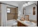 Bathroom featuring a tub, tile backsplash, and vanity with modern fixtures at 1830 W Clinton Dr, St Cloud, FL 34769