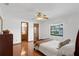 Bright bedroom with hardwood floors, a ceiling fan, and a serene backyard view at 1830 W Clinton Dr, St Cloud, FL 34769