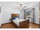 Bedroom showcases hardwood floors, a ceiling fan, and well-lit with a large window at 1830 W Clinton Dr, St Cloud, FL 34769