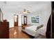 Bright bedroom with hardwood floors, a ceiling fan, and a serene backyard view at 1830 W Clinton Dr, St Cloud, FL 34769