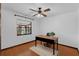 Cozy bedroom featuring hardwood floors, a large window, and a ceiling fan at 1830 W Clinton Dr, St Cloud, FL 34769