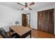 This bedroom features wood floors, a ceiling fan, and closet space at 1830 W Clinton Dr, St Cloud, FL 34769