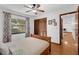 Bedroom showcases hardwood floors, a ceiling fan, and well-lit with a large window at 1830 W Clinton Dr, St Cloud, FL 34769