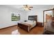 Bedroom features hardwood floors, ceiling fan and an ensuite bathroom at 1830 W Clinton Dr, St Cloud, FL 34769