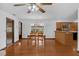 Open dining area featuring hardwood floors, an elegant light fixture, and easy access to the kitchen at 1830 W Clinton Dr, St Cloud, FL 34769