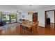 Comfortable dining room with hardwood floors, a stylish light fixture, and views of the living room at 1830 W Clinton Dr, St Cloud, FL 34769