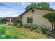 Exterior side view with well-manicured flowerbeds along the house's perimeter at 1830 W Clinton Dr, St Cloud, FL 34769