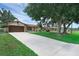 Charming single-story home featuring a stone accent wall and an expansive driveway at 1830 W Clinton Dr, St Cloud, FL 34769
