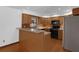 Well-lit kitchen features wood cabinets, a breakfast bar, and stainless steel appliances at 1830 W Clinton Dr, St Cloud, FL 34769