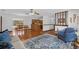 Open concept living space with hardwood floors, stylish rug, and plenty of natural light at 1830 W Clinton Dr, St Cloud, FL 34769