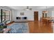 Open-concept living area featuring hardwood floors, a comfortable sofa, and a view to the dining area at 1830 W Clinton Dr, St Cloud, FL 34769