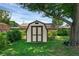 Charming storage shed nestled amongst mature trees and landscaping at 1830 W Clinton Dr, St Cloud, FL 34769
