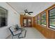 Relaxing sunroom with cozy seating, a ceiling fan, and large windows overlooking the backyard at 1830 W Clinton Dr, St Cloud, FL 34769