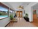 A view of a sunroom showcasing tile floors, a ceiling fan, and exterior pool views at 1830 W Clinton Dr, St Cloud, FL 34769
