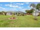 Expansive backyard with screened pool, shed, and lush green lawn, perfect for outdoor activities and relaxation at 2113 Kirkland Lake Dr, Auburndale, FL 33823