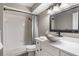 Well-lit bathroom featuring a shower-tub combo, modern vanity, and decorative mirror at 2113 Kirkland Lake Dr, Auburndale, FL 33823