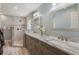 Bathroom featuring a marble countertop, double sinks, a shower with tiled wall and glass blocks at 2113 Kirkland Lake Dr, Auburndale, FL 33823