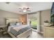 Cozy bedroom features a ceiling fan, wood-look flooring, and a bright window for natural light at 2113 Kirkland Lake Dr, Auburndale, FL 33823