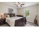 Comfortable bedroom with wood-look flooring, ceiling fan, and natural light from a window at 2113 Kirkland Lake Dr, Auburndale, FL 33823