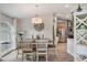 Bright dining room with decor, wood-look tile floors, and a view into the kitchen at 2113 Kirkland Lake Dr, Auburndale, FL 33823