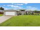 Charming single-story home with a well-manicured lawn and neutral exterior at 2113 Kirkland Lake Dr, Auburndale, FL 33823