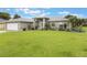 Charming single-story home with a well-manicured lawn and neutral exterior at 2113 Kirkland Lake Dr, Auburndale, FL 33823