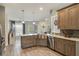 Open concept kitchen with stainless steel appliances, light countertops, and wood cabinets at 2113 Kirkland Lake Dr, Auburndale, FL 33823