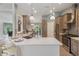 Open kitchen with stainless appliances, quartz countertops, and stylish backsplash at 2113 Kirkland Lake Dr, Auburndale, FL 33823