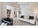 Living room with open concept kitchen, modern sofa, and decorative elements at 2113 Kirkland Lake Dr, Auburndale, FL 33823