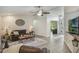 Cozy living room featuring wood-look tile floors, a ceiling fan, and neutral decor at 2113 Kirkland Lake Dr, Auburndale, FL 33823