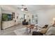 Comfortable living room with a leather sofa, ceiling fan, and access to outdoor patio at 2113 Kirkland Lake Dr, Auburndale, FL 33823