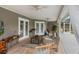 Covered patio area with stylish wicker furniture, ceiling fans, and serene outdoor space at 2113 Kirkland Lake Dr, Auburndale, FL 33823