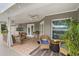 Inviting covered patio with wicker seating, ceiling fan, and lush greenery for relaxing outdoors at 2113 Kirkland Lake Dr, Auburndale, FL 33823