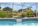Sparkling pool with attached spa featuring mosaic tile and landscaping, perfect for relaxation and enjoyment at 2113 Kirkland Lake Dr, Auburndale, FL 33823