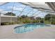 Inviting screened-in pool surrounded by a spacious deck, perfect for outdoor entertaining and relaxation at 2113 Kirkland Lake Dr, Auburndale, FL 33823