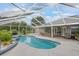 Gorgeous screened-in pool with lounge area and a tranquil outdoor sitting area to enjoy the beautiful weather at 2113 Kirkland Lake Dr, Auburndale, FL 33823
